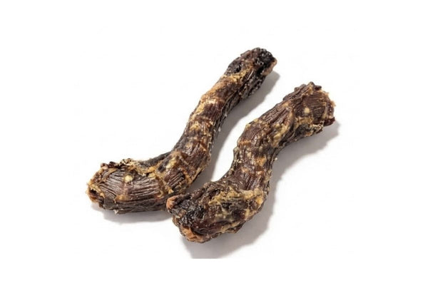 Two dried duck necks for dogs on a white background, showing their ridged texture
