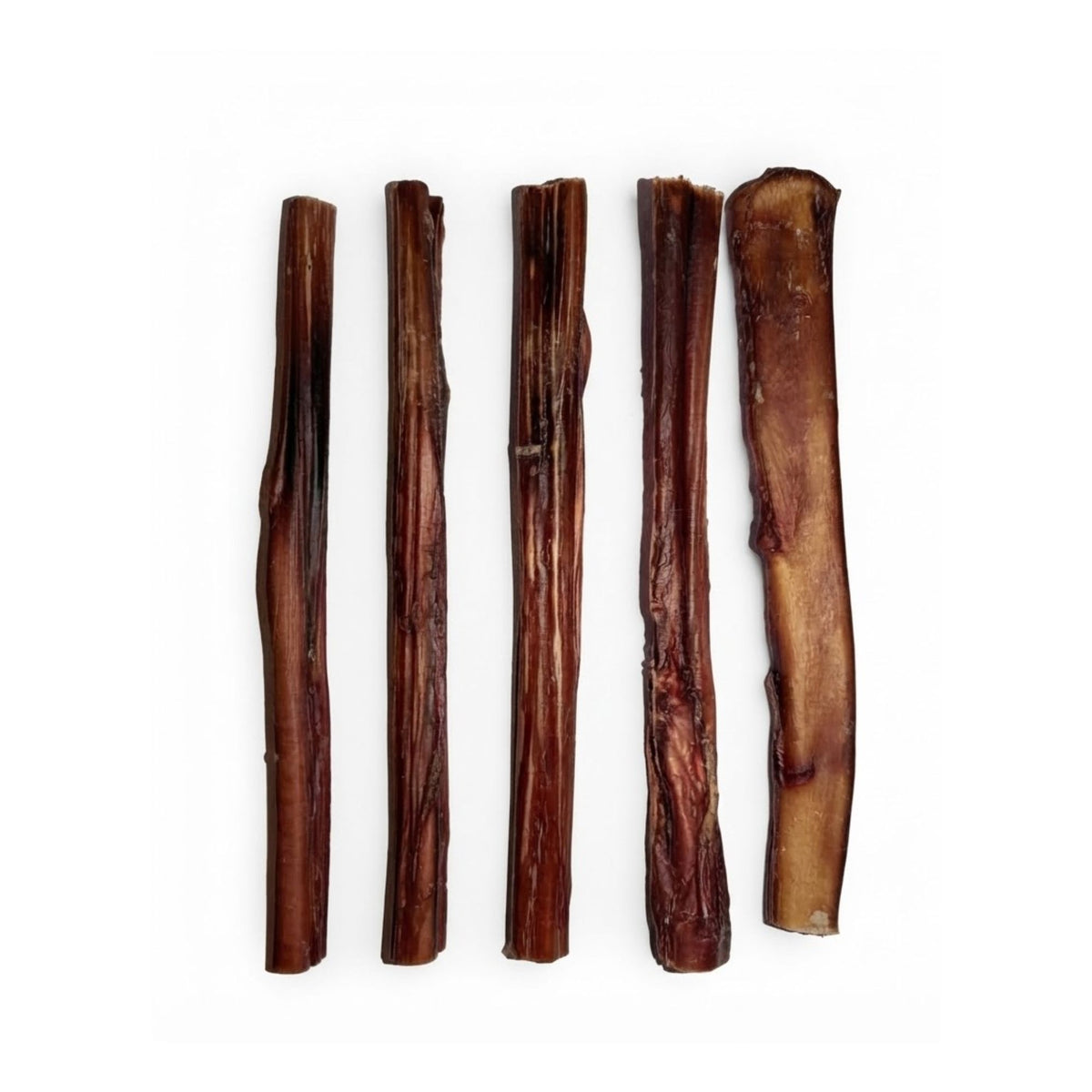 Five dried beef pizzle bully sticks laid out on a white background