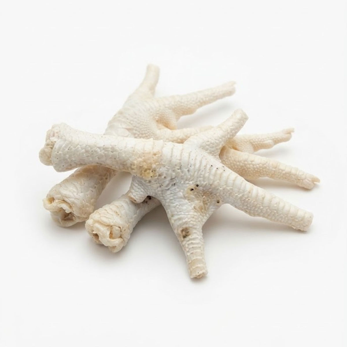 A pile of puffed chicken feet for dogs on a white background