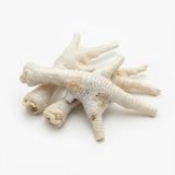 A pile of puffed chicken feet for dogs on a white background
