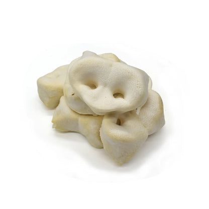 A pile of puffed pig snouts for dogs on a white background