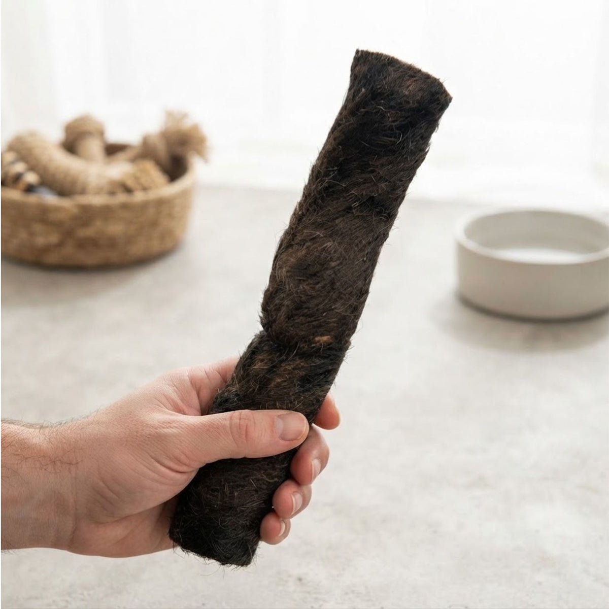 Hand holding a furry buffalo wrap to show its size
