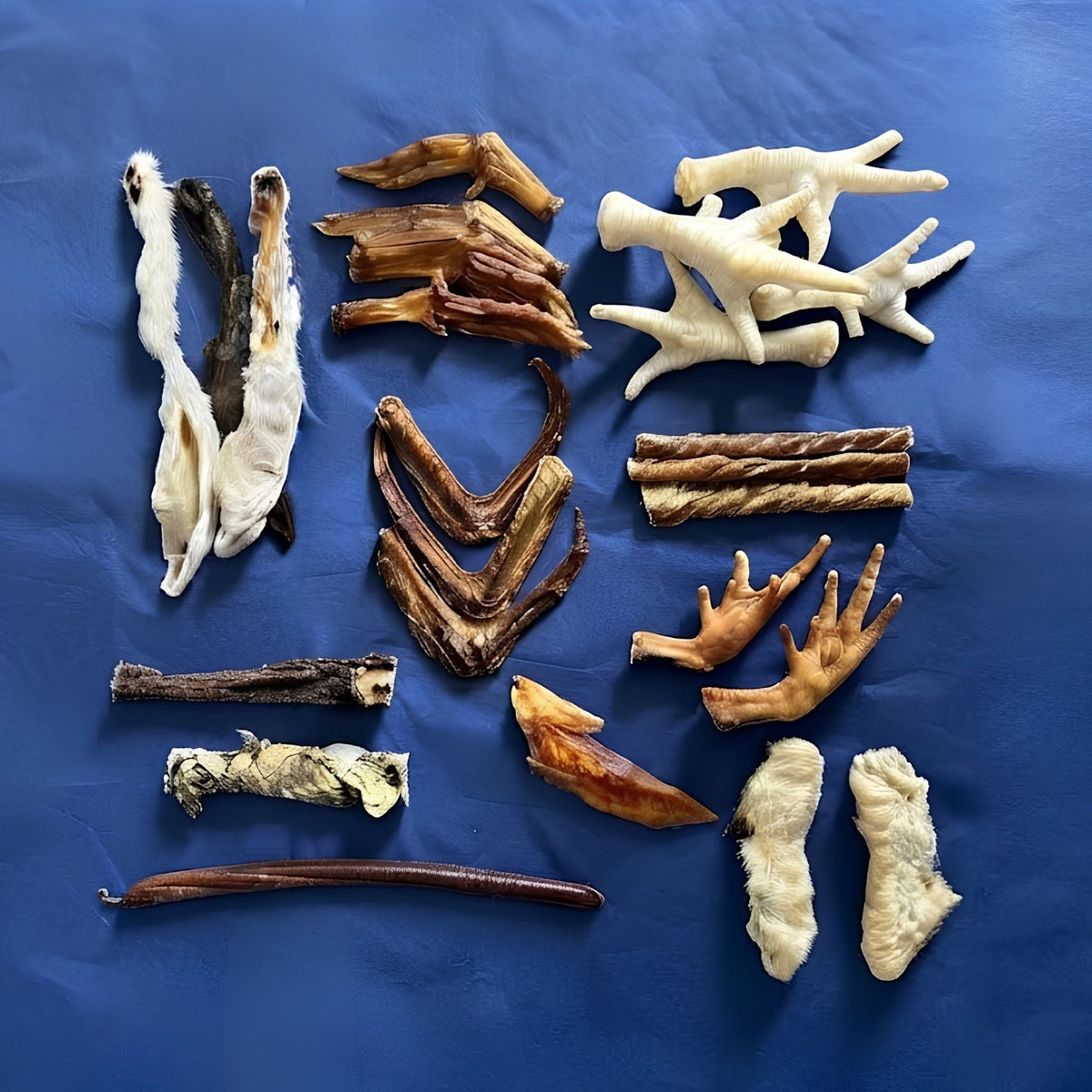 The contents of the bag laid out on a blue background, showing every treat in the mix side by side