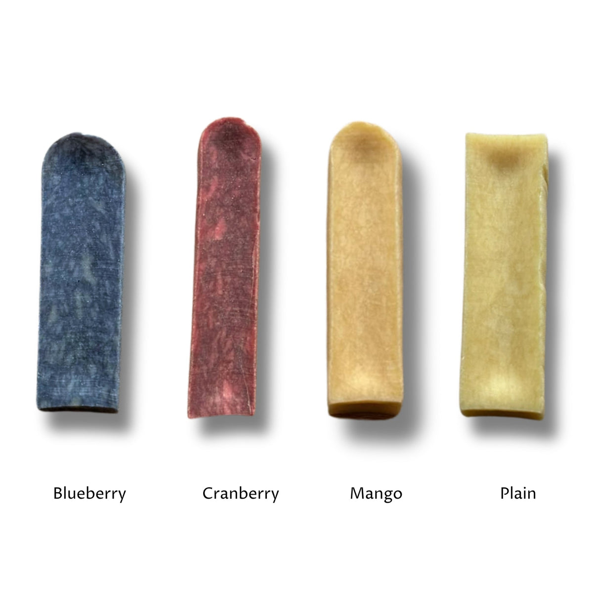 Four chews side by side, the blueberry, cranberry and mango milk chews next to the plain yak chew, labelled by flavour