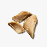 Three natural calf hooves for dogs on a white background