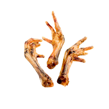 Three dried chicken feet dog treats on a white background